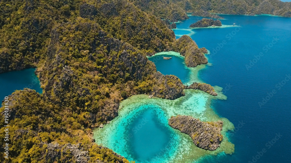 Aerial view: Mountain Barracuda lake, on tropical island, Lagoon with blue, azure water. Lake in the mountains covered with tropical forest on the island Coron, Palawan, Philippines.