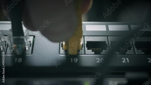 hands plug in the ethernet cable