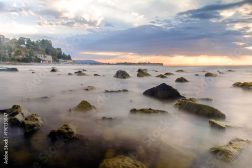 Rocks in the black sea and cloudy sky in sunrise. Nesebar Bulgaria Long exposition.