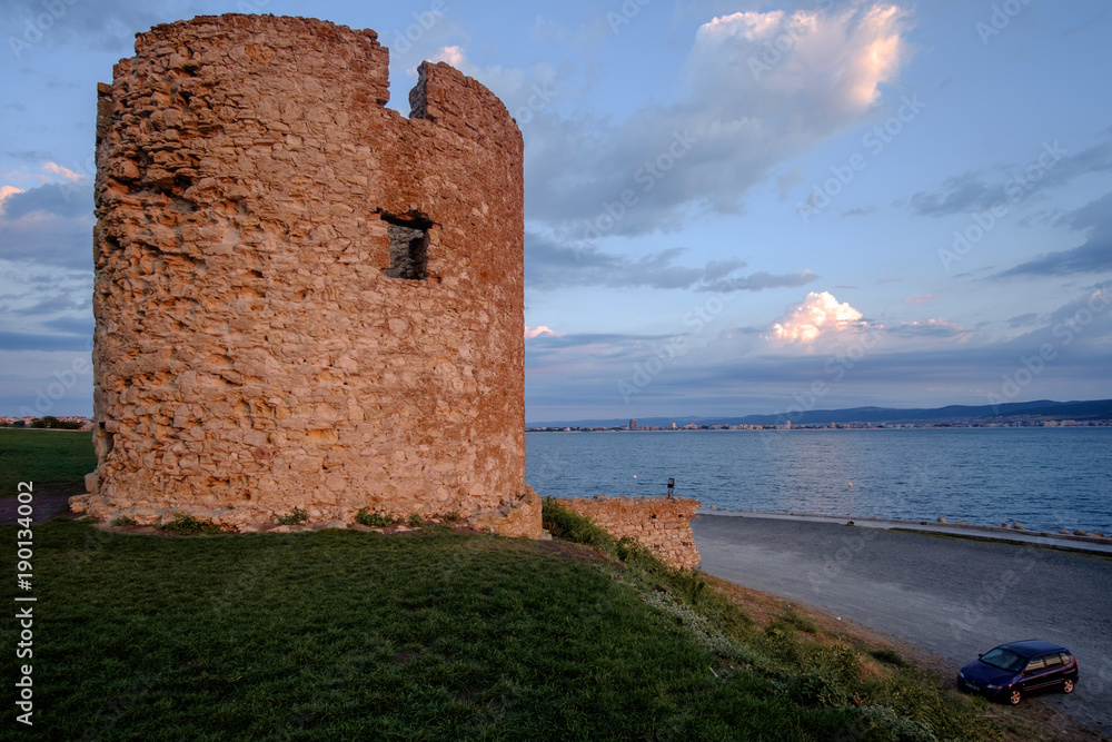 Sunrise and ruins of the castle tower on the Black Sea coast in the Ancient City of Nesebar