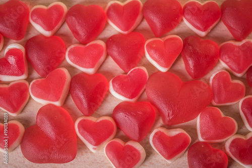 jelly gummy red heart shape candy filled frame background 