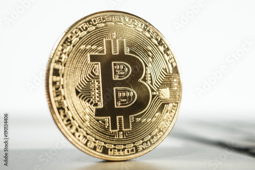 New virtual money Golden bitcoin coin on a white. Cryptocurrency. Business and Trading concept.