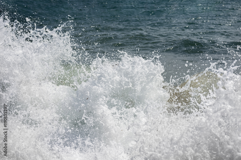 Crashed wave - foam and spray. Mediterranean sea. Tension and struggle conception. Texture. Crashed wave - foam and spray. Mediterranean sea. Tension and struggle conception. Texture.