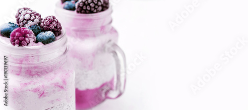 chia with yoghurt, frozen bananas and wild berries, on a white background