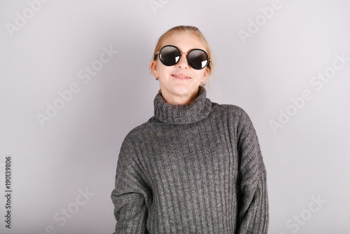 Portrait of a young smiling teenage girl with sunglasses.