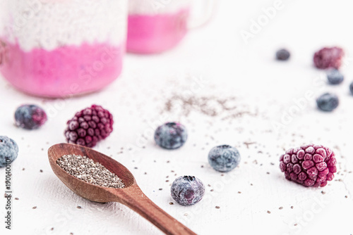 chia with yoghurt, frozen bananas and wild berries, on a white background