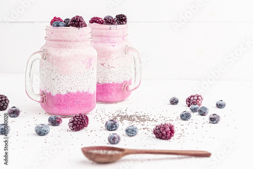 chia with yoghurt, frozen bananas and wild berries, on a white background