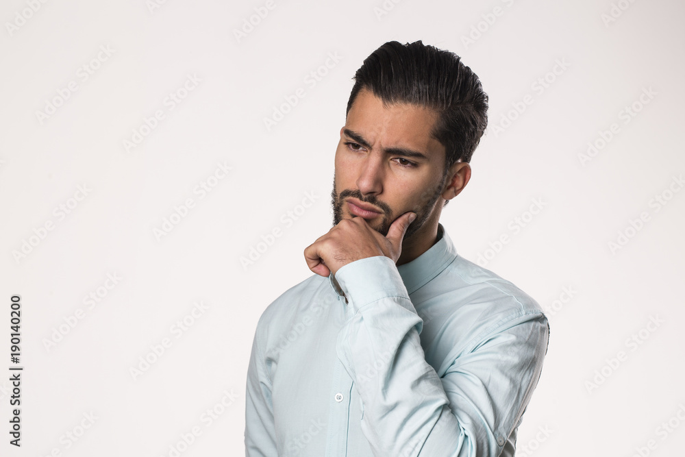 handsome bearded man thinking being pensive isolated on studio background handsome bearded man thinking being pensive isolated on studio background