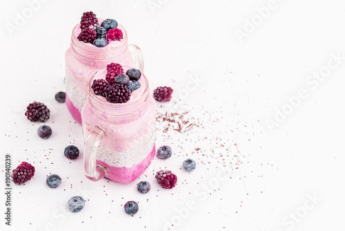 chia with yoghurt, frozen bananas and wild berries, on a white background