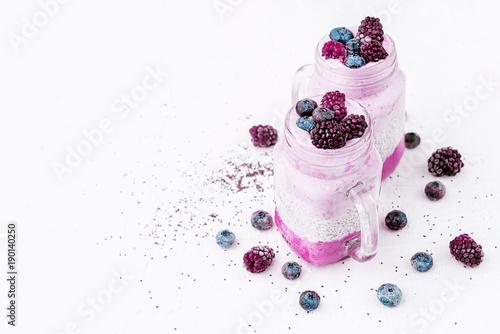 chia with yoghurt, frozen bananas and wild berries, on a white background