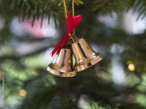 Christmas bells decoration hanging from a christmas tree