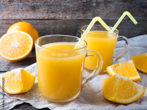 Fresh orange juice on wooden background  rustic style