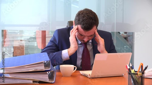 Massage head temples confused exhausted tired executive indoors man with laptop