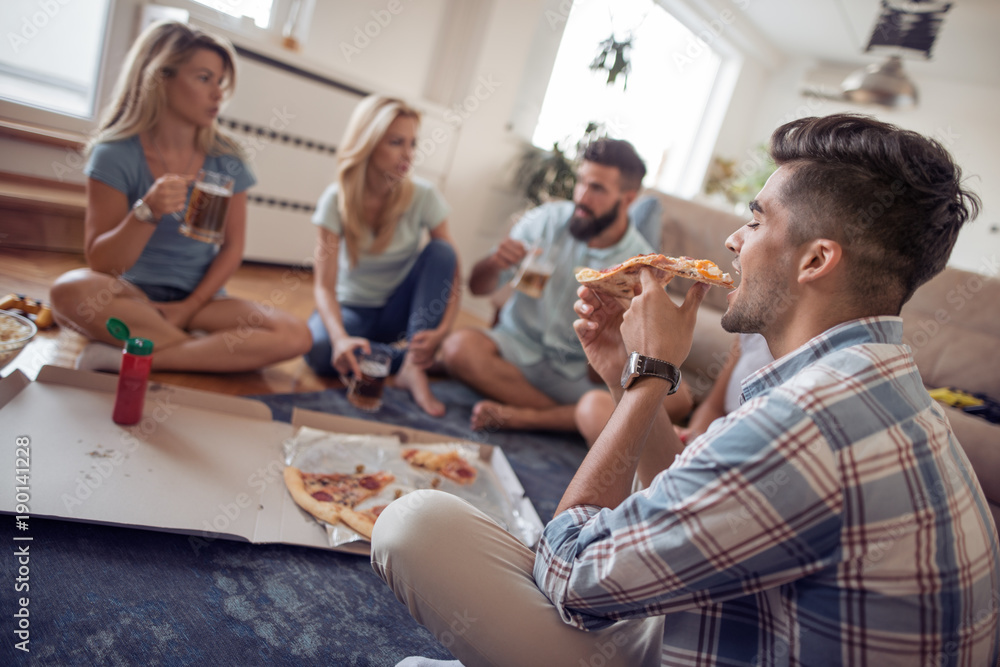 Friends having party at home, eating pizza and having fun. Friends having party at home, eating pizza and having fun.