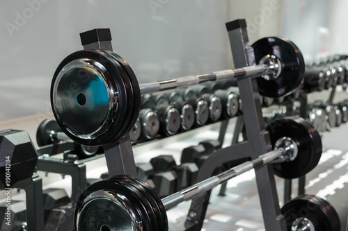 Fototapeta Naklejka Na Ścianę i Meble -  Steel Disks and Barbells in Gym: Weight Fitness Equipment