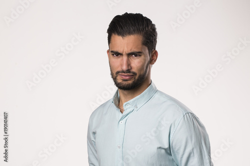 Face of an angry furious and frustrated male on a white background