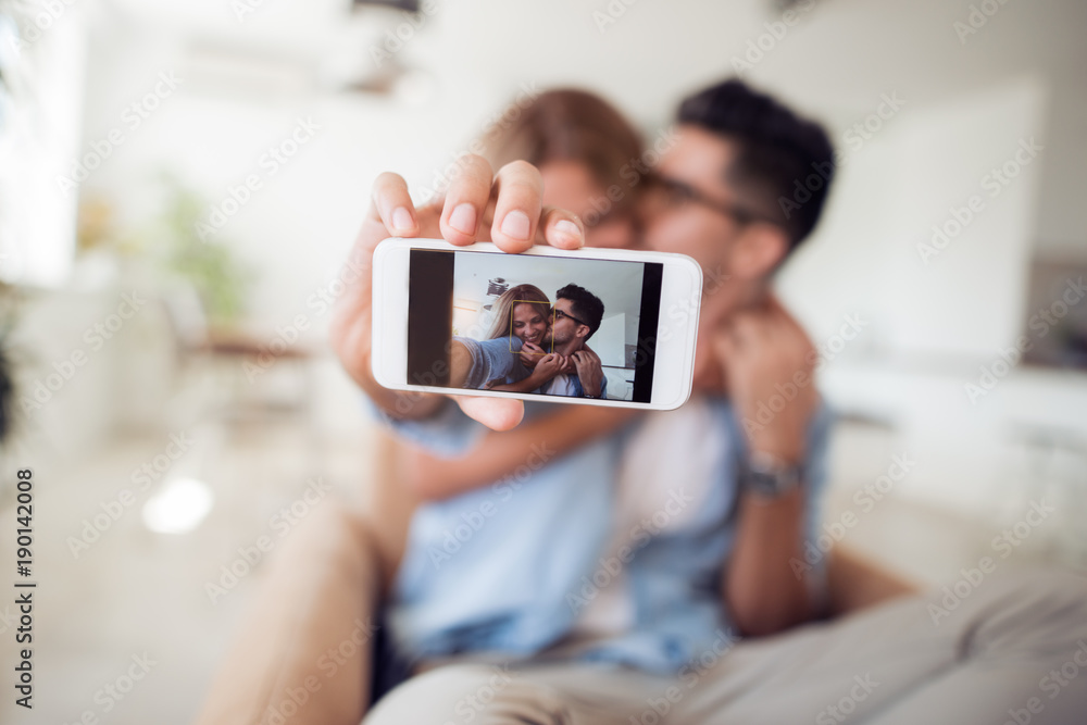 Portrait of a happy couple making selfie photo.