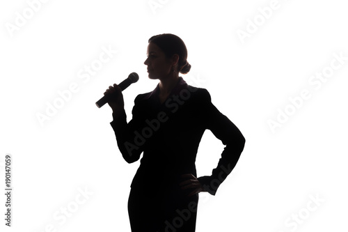 Young woman singing into the microphone
