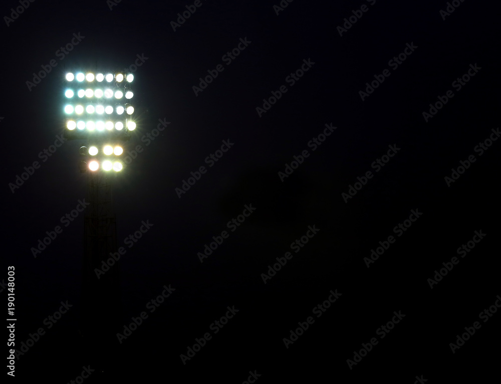 headlights lit in a stadium