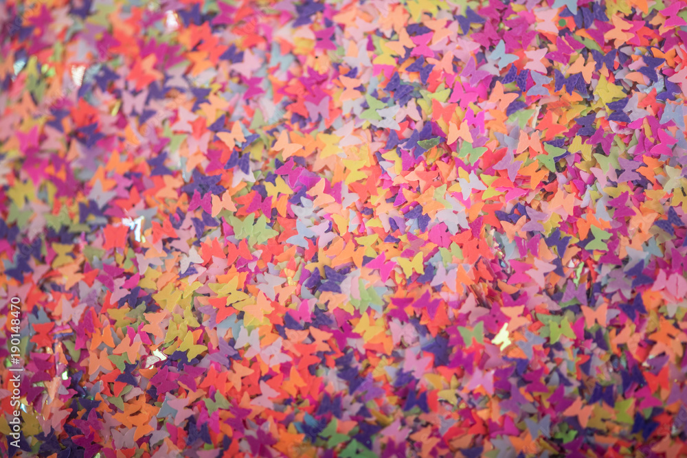 colourful background of small tiny butterfly shape glitter 