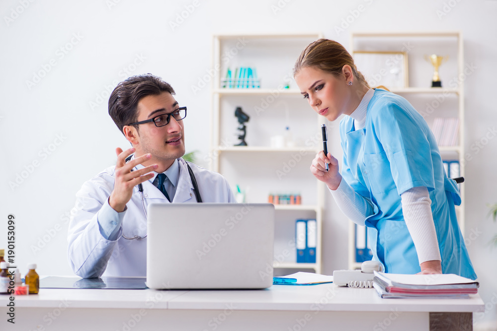 Fototapeta premium Male and female doctor having discussion in hospital