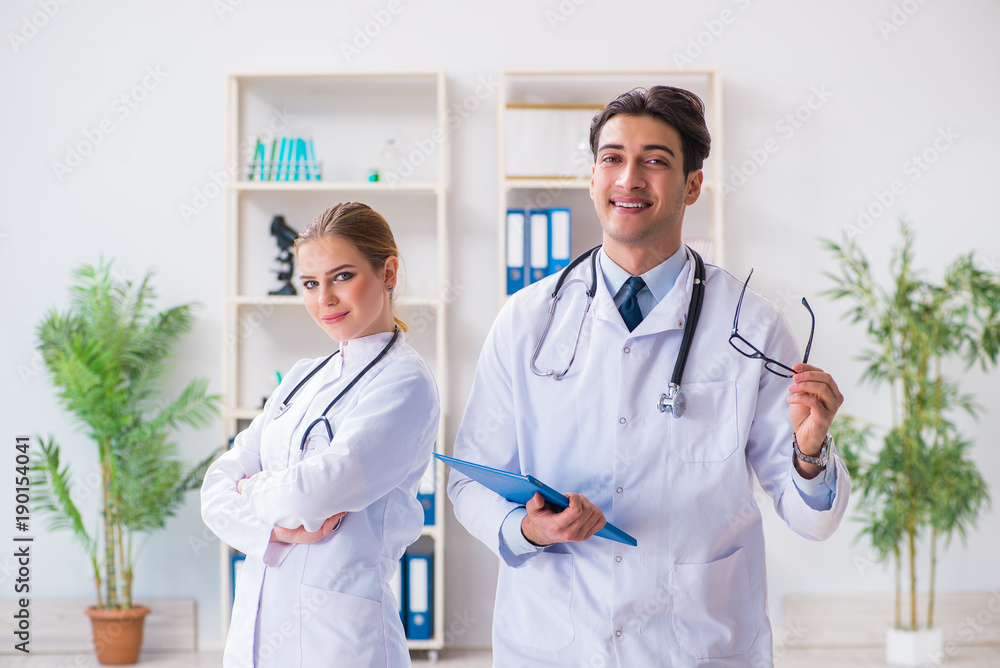 Male and female doctor having discussion in hospital Male and female doctor having discussion in hospital