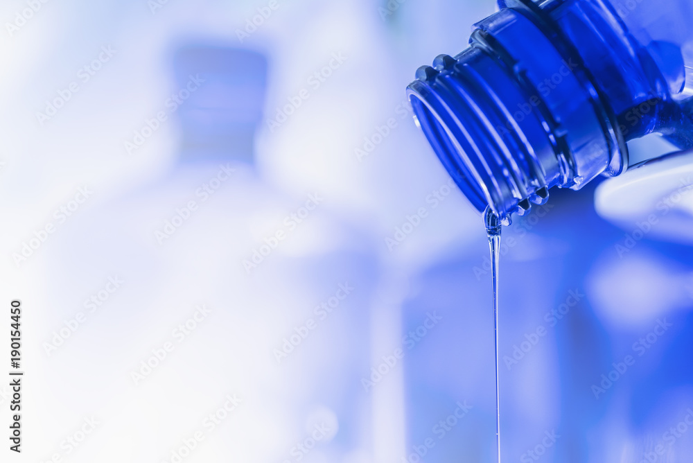 Remains liquids flow from the neck of the bottle close-up. Remains liquids flow from the neck of the bottle close-up.