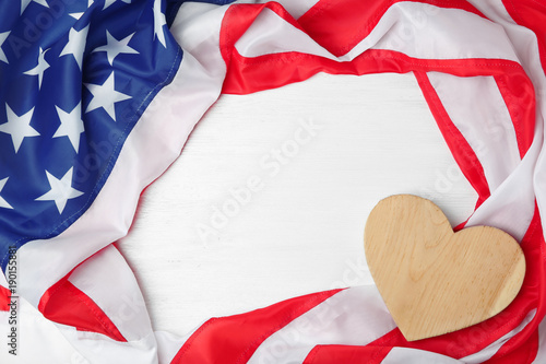Obraz na plátne Wooden heart and American flag on light background. USA holiday