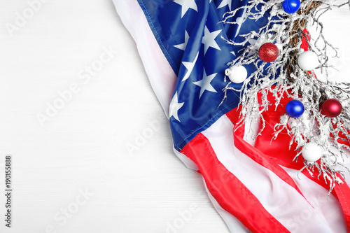 Christmas wreath and American flag on wooden table