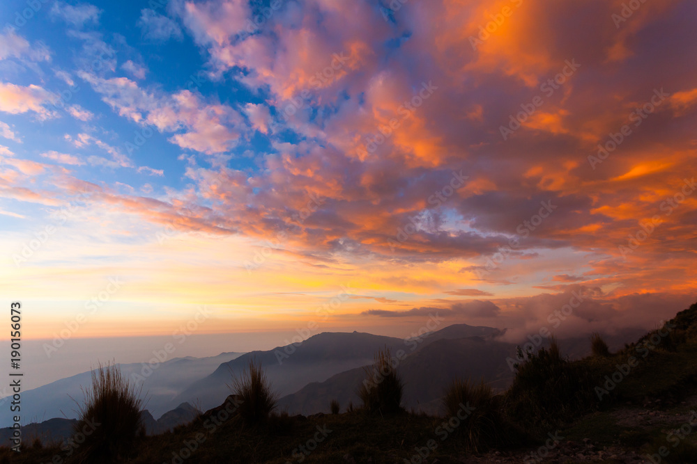 Red, orange, yellow clouds, with blue sky Red, orange, yellow clouds, with blue sky