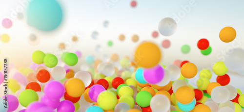 Fotografija colorful bouncing balls outdoors against blue sunny sky