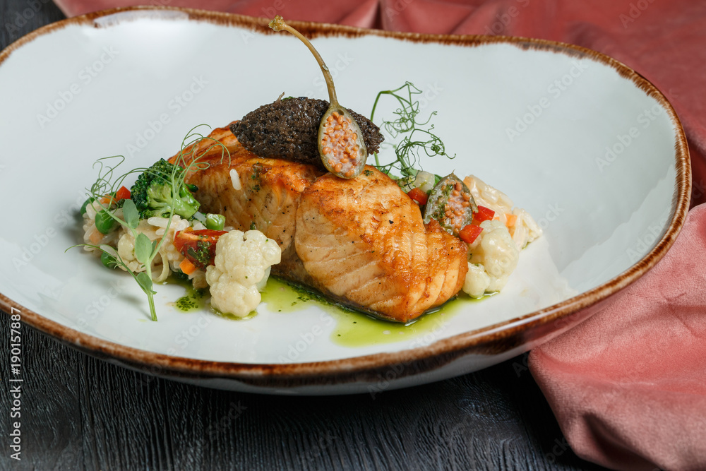 grilled salmon with lime, asparagus and cherry tomatoes on white plate grilled salmon with lime, asparagus and cherry tomatoes on white plate