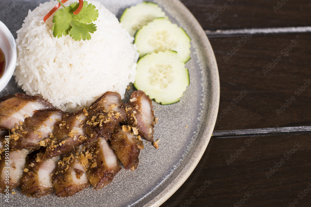 Deep Fried Pork Belly over Rice served with spicy sauce Deep Fried Pork Belly over Rice served with spicy sauce