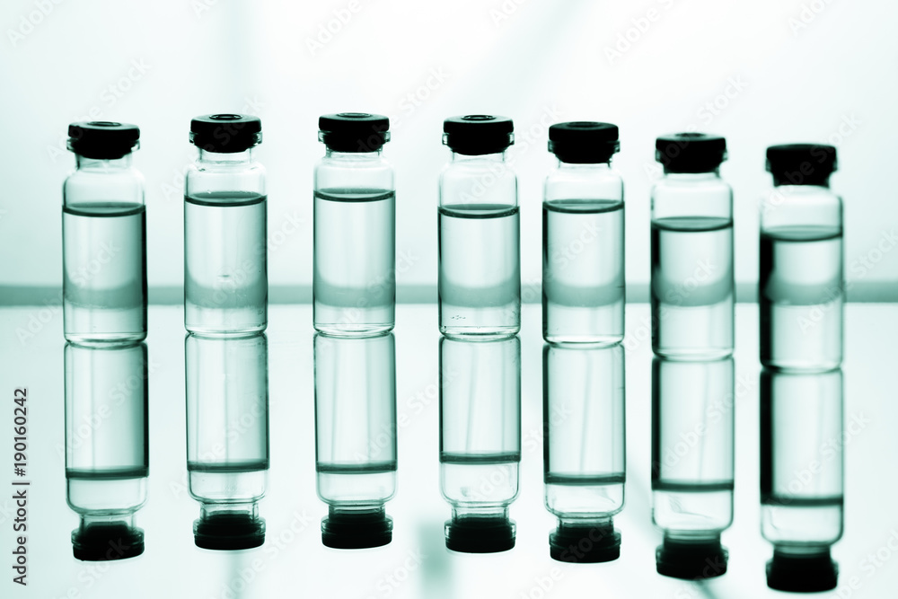 Group of ampoules with a transparent medicine in medical laboratory Group of ampoules with a transparent medicine in medical laboratory