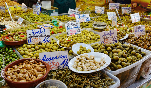 Assortment of olives and pickles at market stand