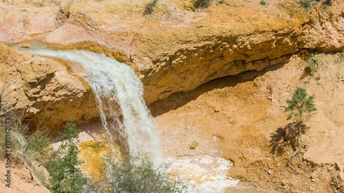 Small creek among yellow cliffs. Green pine-trees on rock slopes. Amazing mountain landscape. Bryce Canyon National Park. Utah. USA. 4K, 3840*2160, high bit rate, UHD