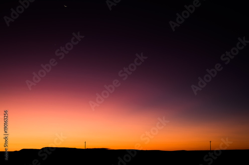 Vibrant Rural Montana Sunrise with Power Lines Silhouette