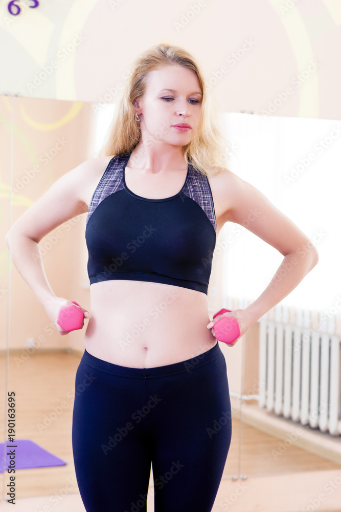Sport, Fitness, Wellness and Lifestyle Concepts. Closeup of Caucasian Sexy Female Athlete Posing With Barbells In Gym.