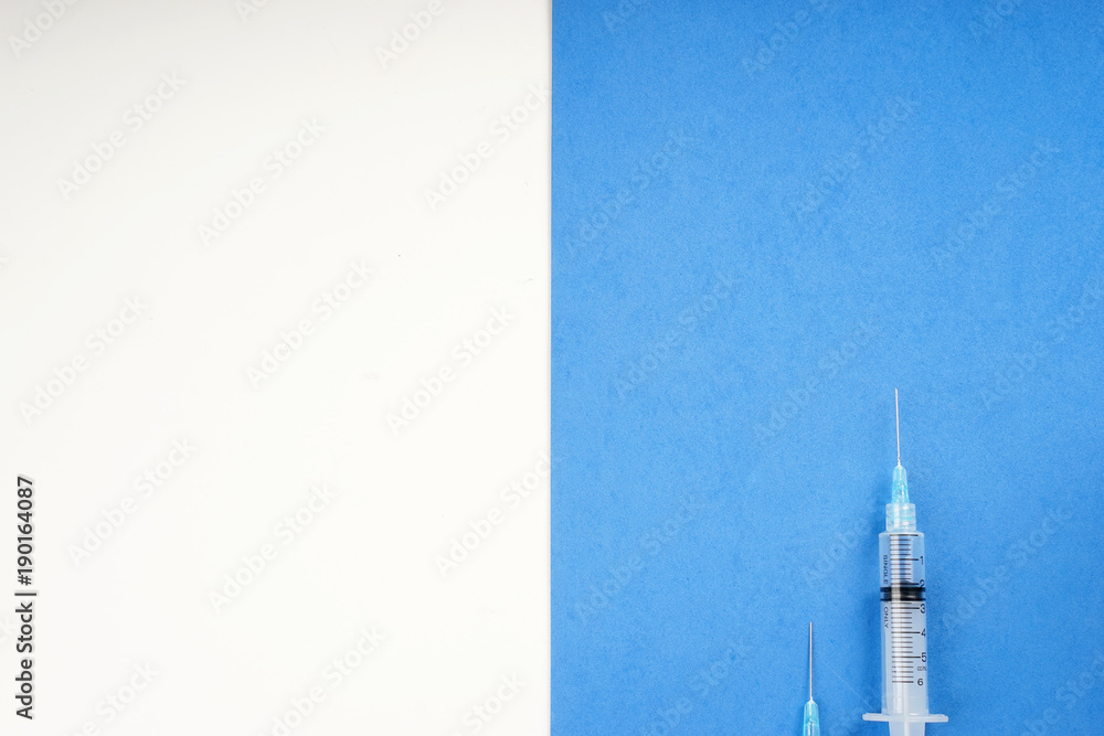 Syringe on a pastel background Syringe on a pastel background