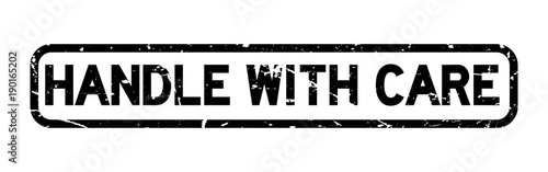 Grunge black handle with care square rubber seal stamp on white background