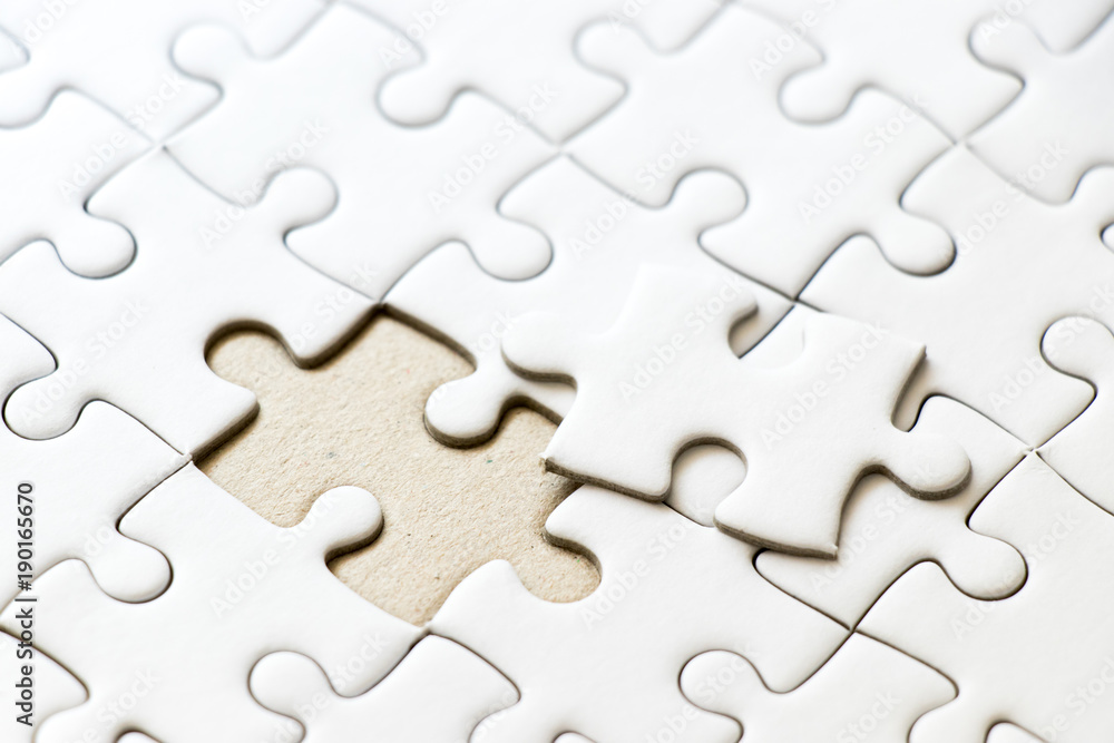 Closed up background of white plain jigsaw wait missing piece to match or fulfill Closed up background of white plain jigsaw wait missing piece to match or fulfill