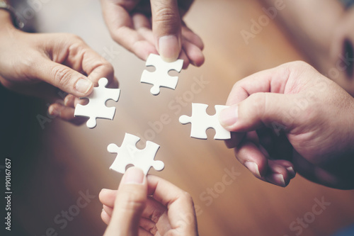 Hand holding jigsaw puzzles, Business partnership concept. photo