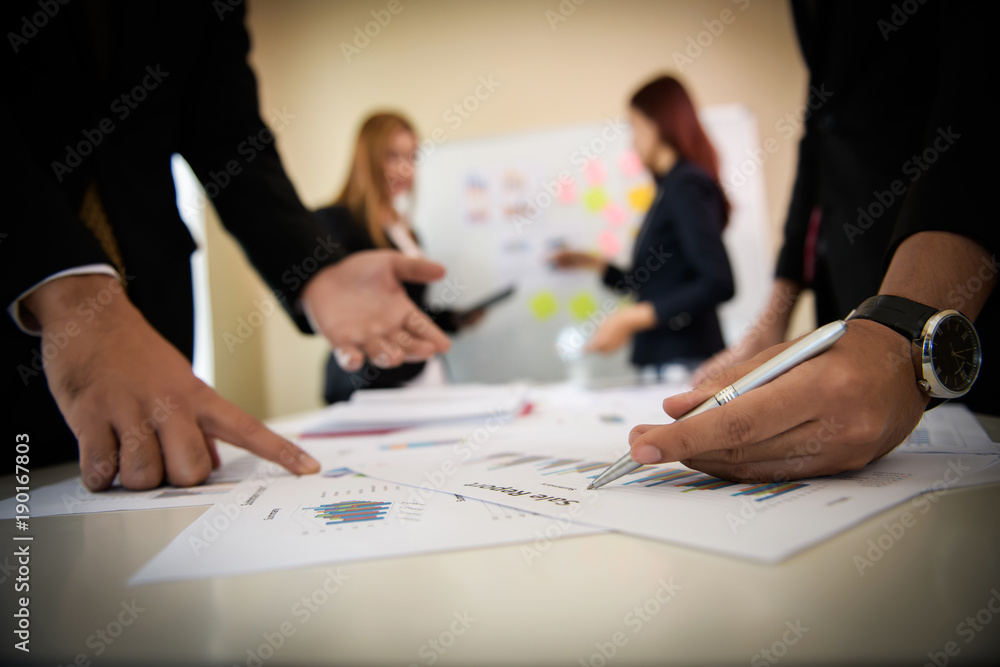 Startup business people group meeting. People group sitting on conference together and making notes. hands pointing at business document during discussion at meeting. Startup business people group meeting. People group sitting on conference together and making notes. hands pointing at business document during discussion at meeting.