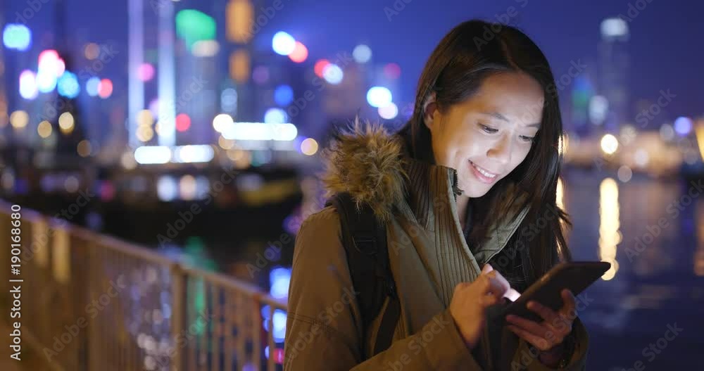 Man using mobile phone in city at night