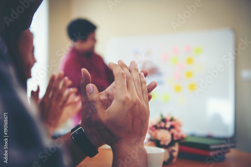 Happy group of business people clapping in office meeting hands applauding at conference success and perfect presentation.