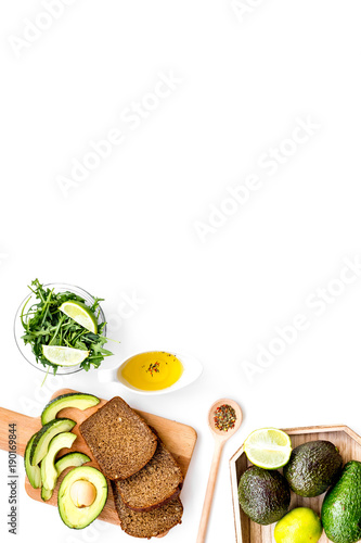 Fototapeta Naklejka Na Ścianę i Meble -  Avocado toast for light healthy breakfast on white background top view copy space