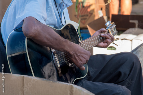 close up of Man playing guitar in outdorr market