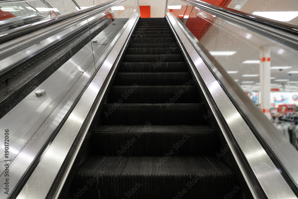 Modern escalator indoors in the shopping mall Modern escalator indoors in the shopping mall