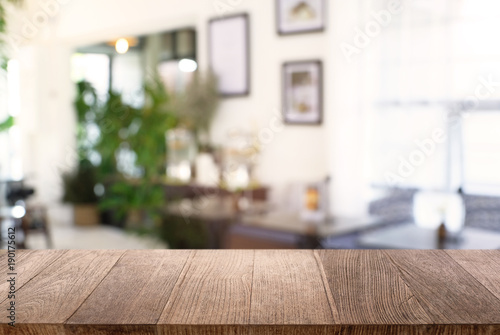 Fototapeta Naklejka Na Ścianę i Meble -  Empty wooden table in front of abstract blurred background of coffee shop . can be used for display or montage your products.Mock up for display of product.