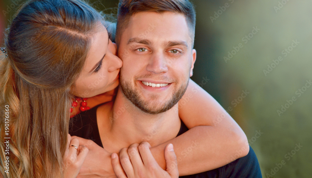 Pretty couple hugging and flirting in an urban park Pretty couple hugging and flirting in an urban park